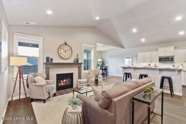 living room with lofted ceiling and light hardwood / wood-style floors