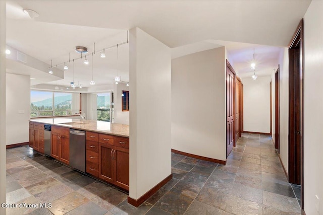 bathroom with stone tile flooring, vanity, and baseboards