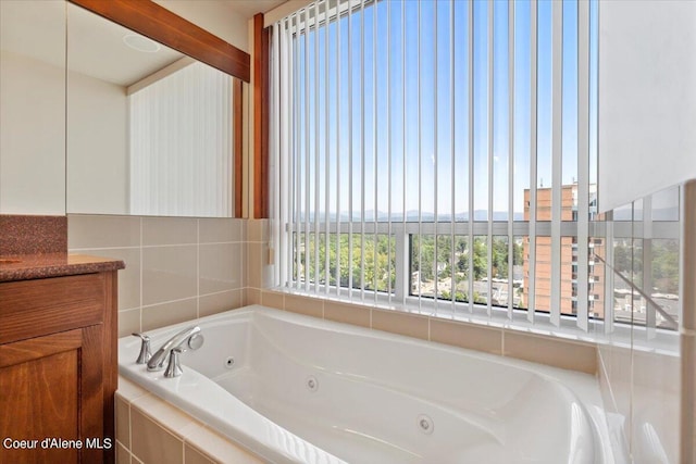 bathroom with a jetted tub and vanity