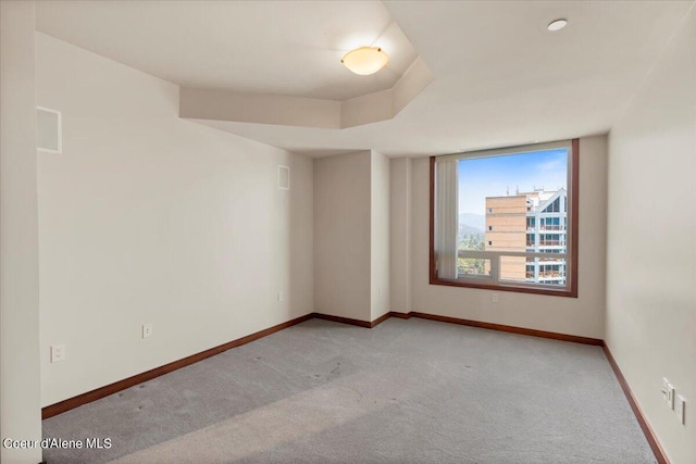 empty room with baseboards and light colored carpet