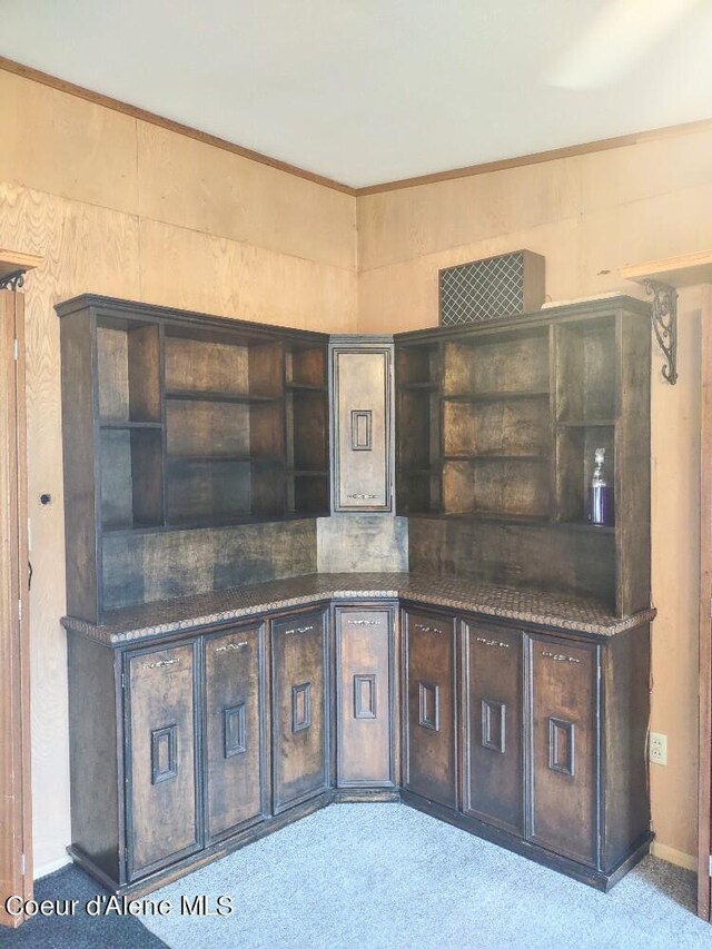 kitchen with light carpet and dark brown cabinets