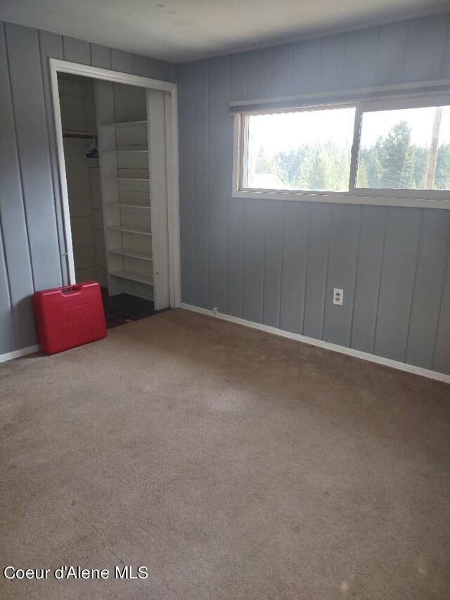 unfurnished bedroom with a closet and carpet