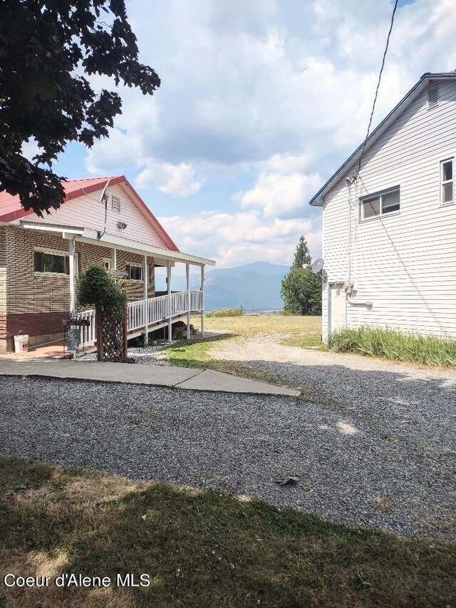 view of property exterior with a mountain view