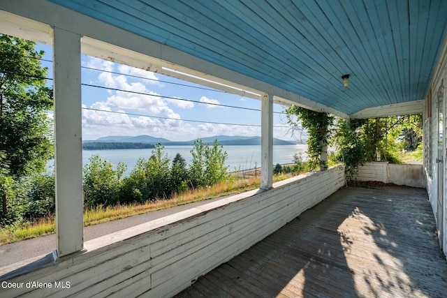 view of patio with a water and mountain view