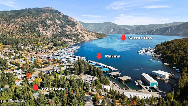 aerial view featuring a water and mountain view