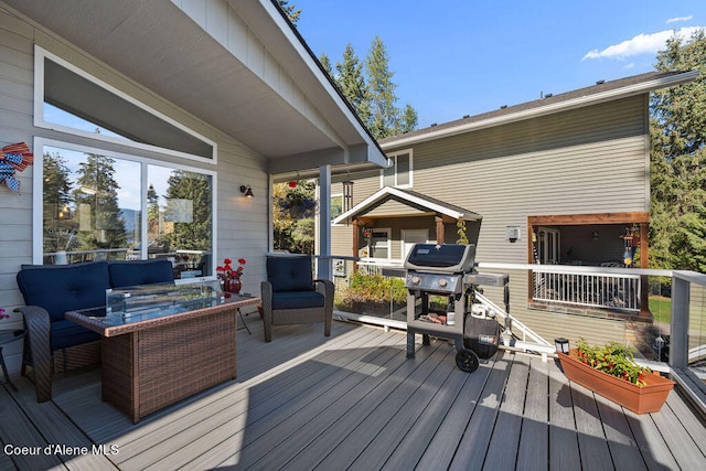 deck featuring an outdoor living space and area for grilling