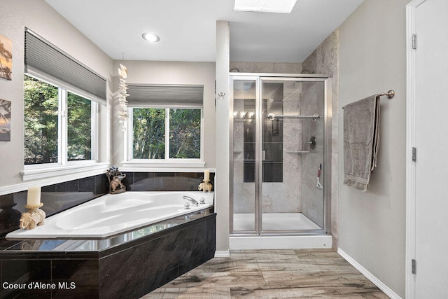 bathroom featuring shower with separate bathtub