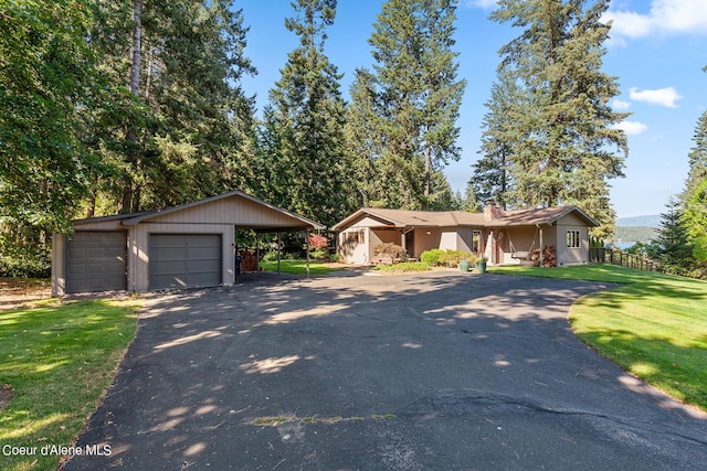 9740 N Easy St, Hayden Lake, ID 83835 - view of front of home with a front lawn, driveway, an outdoor structure, and a garage