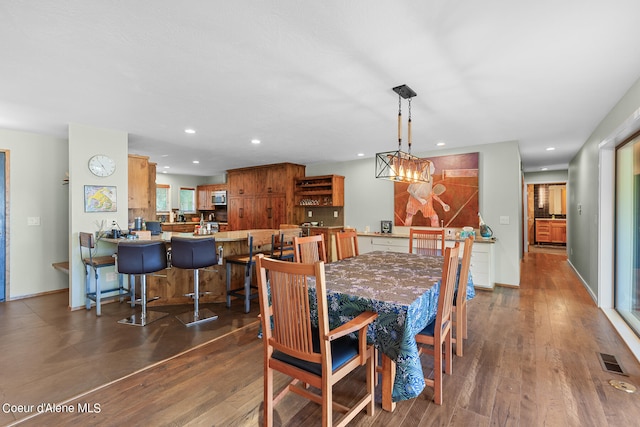 dining space featuring an inviting chandelier and hardwood / wood-style floors