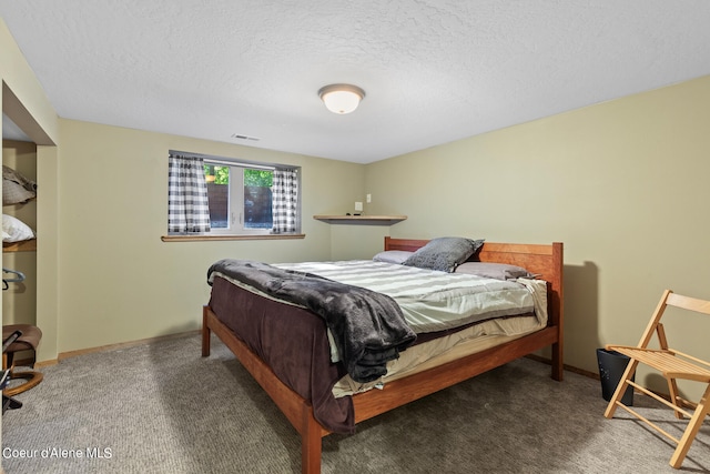 carpeted bedroom featuring a textured ceiling