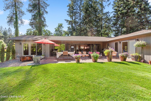 back of property with a patio, outdoor lounge area, and a yard