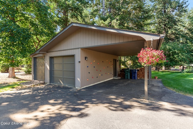 garage with a carport and a yard