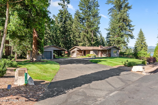 single story home with a garage, a carport, and a front yard