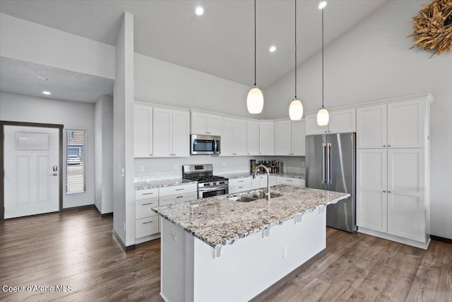 kitchen with white cabinetry, an island with sink, stainless steel appliances, and sink