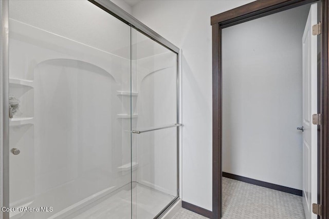 bathroom featuring a shower with door