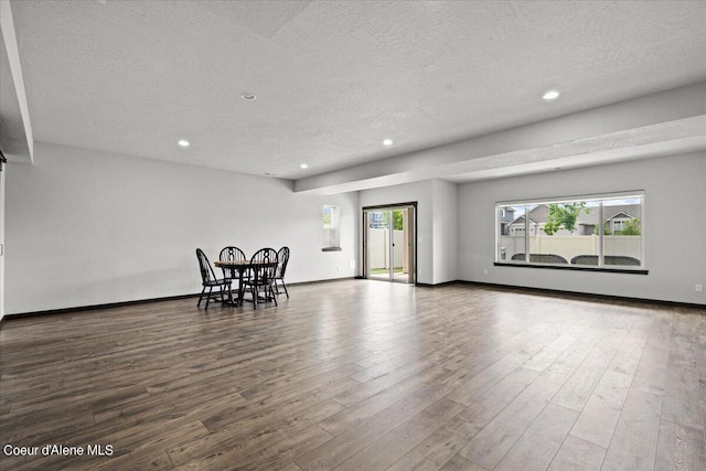 living room featuring hardwood / wood-style flooring and a textured ceiling