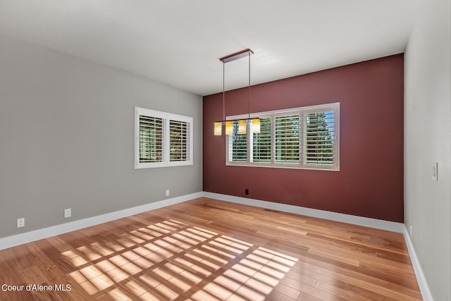 unfurnished room featuring hardwood / wood-style floors