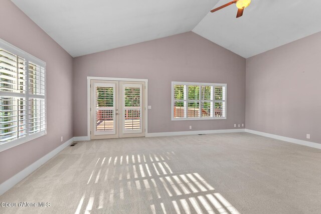 unfurnished living room featuring lofted ceiling, light colored carpet, french doors, and ceiling fan