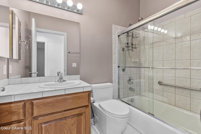 full bathroom with enclosed tub / shower combo, vanity, and toilet