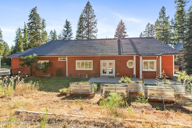 rear view of property featuring a patio and french doors