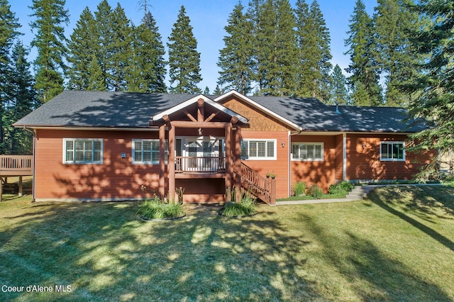 rear view of house featuring a lawn