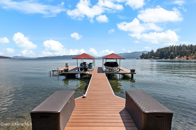 view of dock featuring a water and mountain view and boat lift