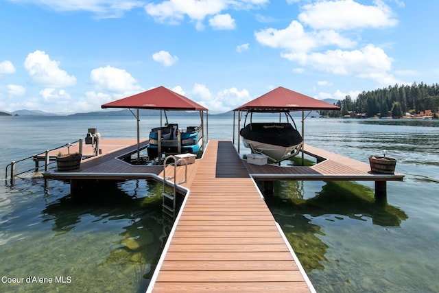 view of dock with boat lift and a water view