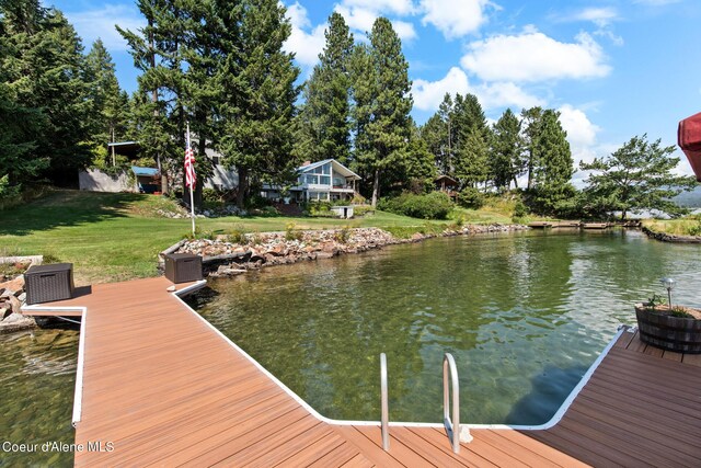 dock area with a water view and a lawn