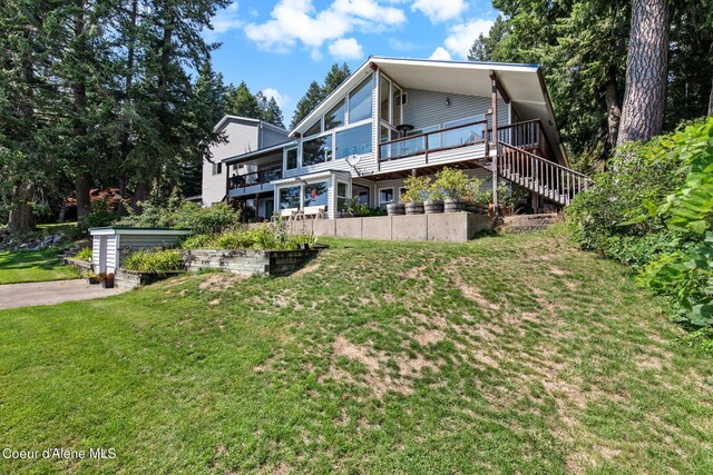 view of side of property with a lawn and a deck