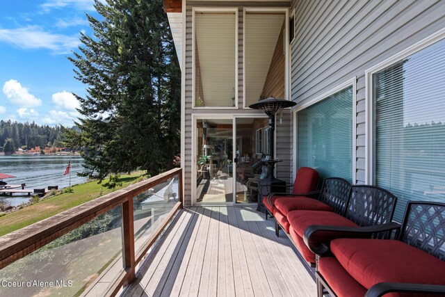 wooden deck featuring a water view