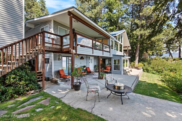 back of property with a patio and a deck