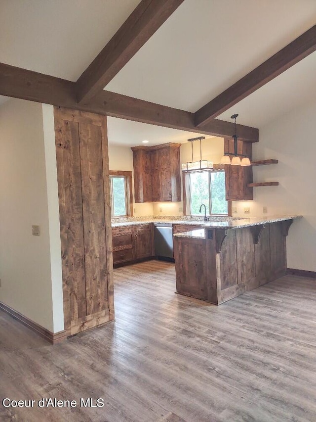 kitchen with hardwood / wood-style floors, pendant lighting, kitchen peninsula, light stone countertops, and dishwasher