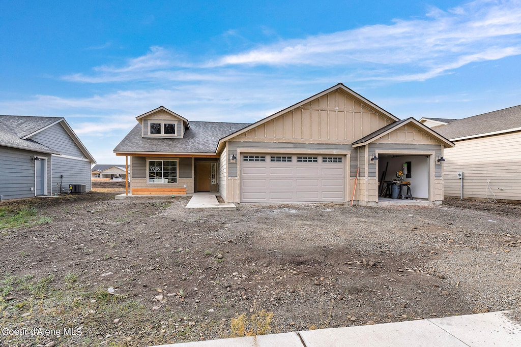 view of front of house featuring a garage and central air condition unit