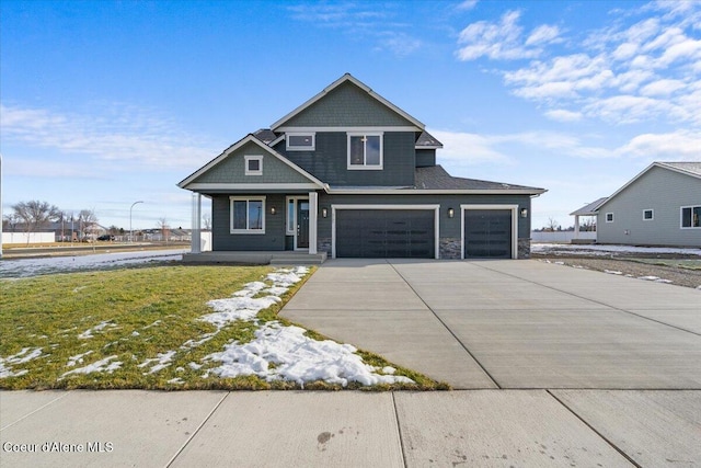 view of front of property featuring a garage and a front lawn