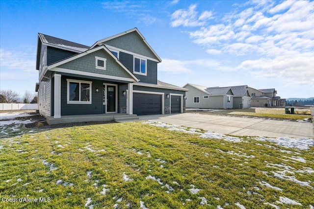 view of front facade with a garage, a front yard, and covered porch