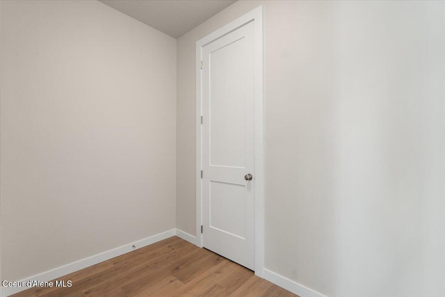 hallway with light hardwood / wood-style floors