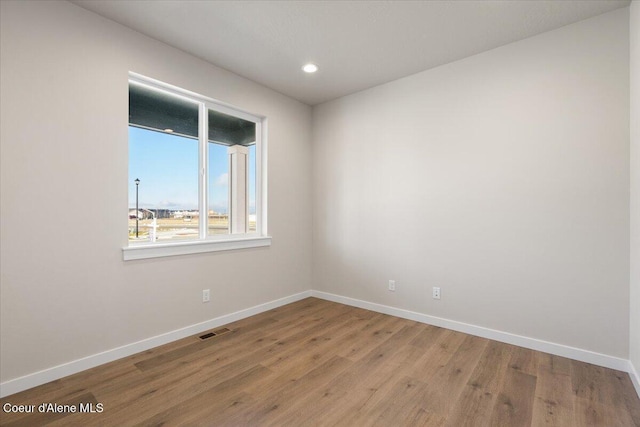 unfurnished room with hardwood / wood-style floors