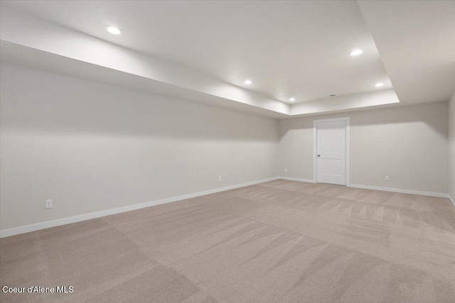 basement featuring light carpet