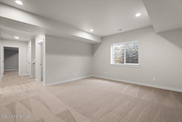 additional living space featuring light carpet