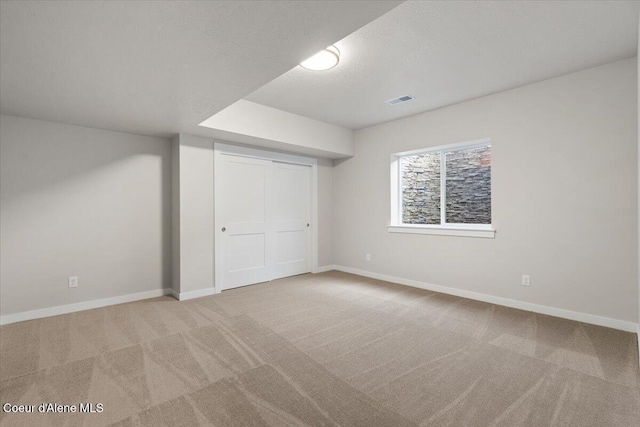 unfurnished bedroom featuring carpet flooring, a textured ceiling, and a closet