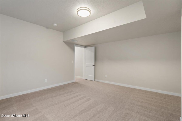 carpeted spare room featuring a textured ceiling