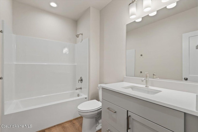 full bathroom featuring vanity, wood-type flooring, shower / tub combination, and toilet