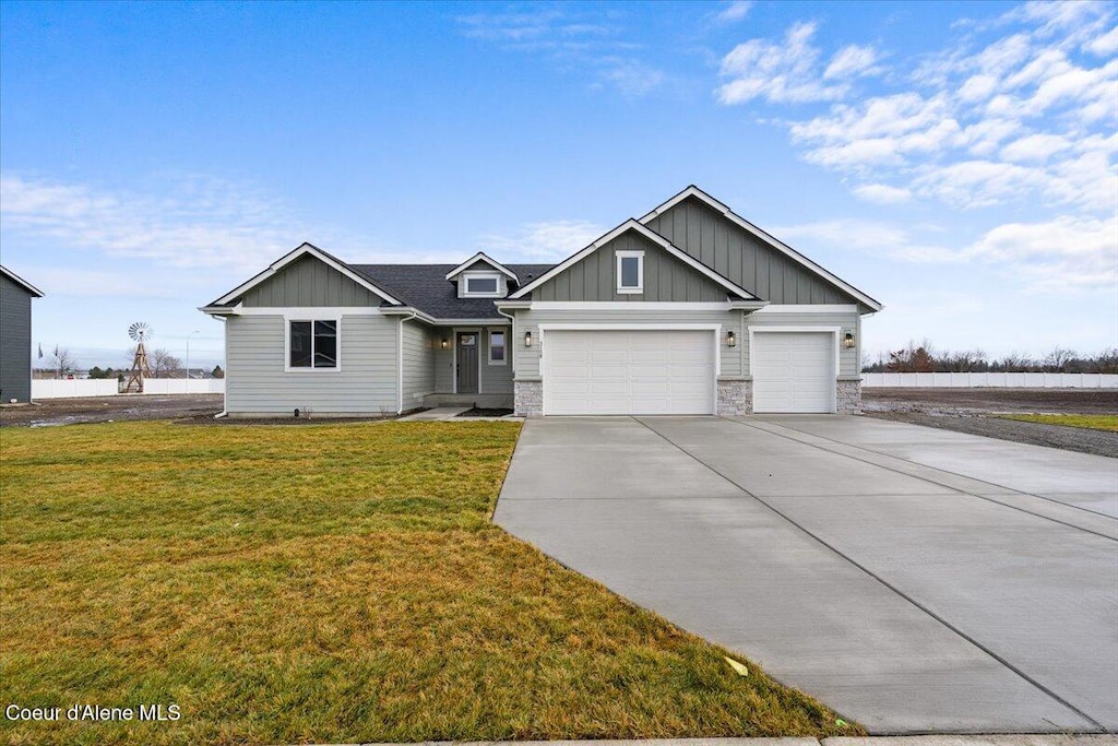 view of front of property with a front lawn and a garage