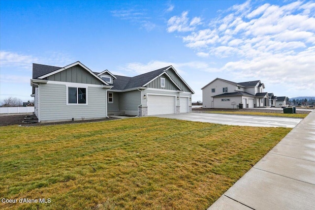 view of front of property featuring a front yard and a garage