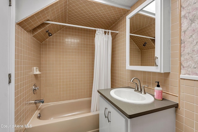 full bath featuring shower / tub combo, tile walls, and vanity