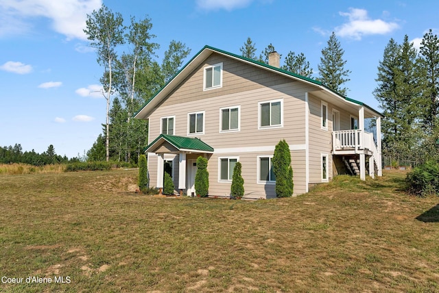 view of front of property featuring a chimney and a front lawn