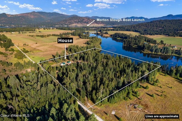 drone / aerial view featuring a rural view and a water and mountain view