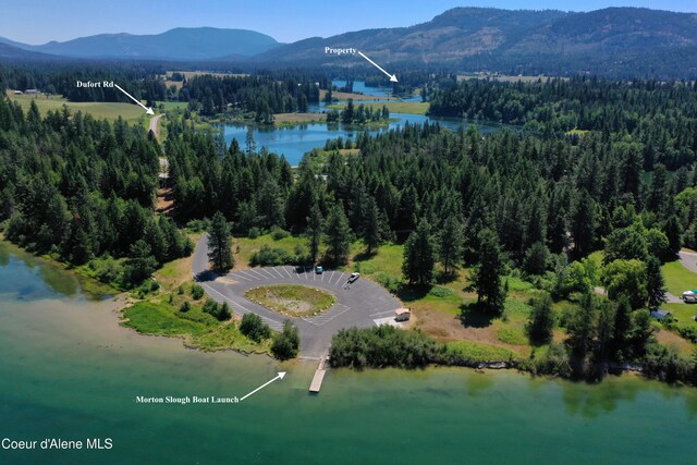 bird's eye view with a wooded view and a water and mountain view