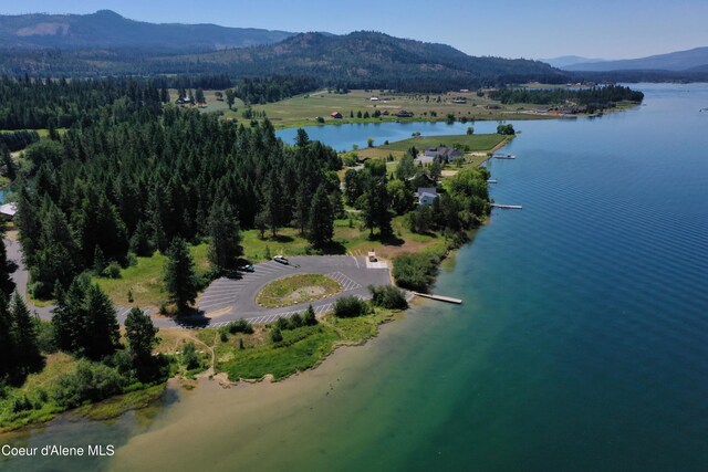 birds eye view of property featuring a water and mountain view