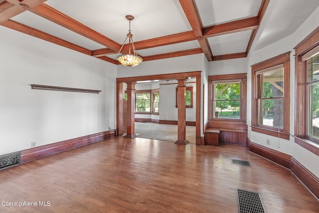 spare room featuring hardwood / wood-style flooring, a wealth of natural light, coffered ceiling, and ornate columns